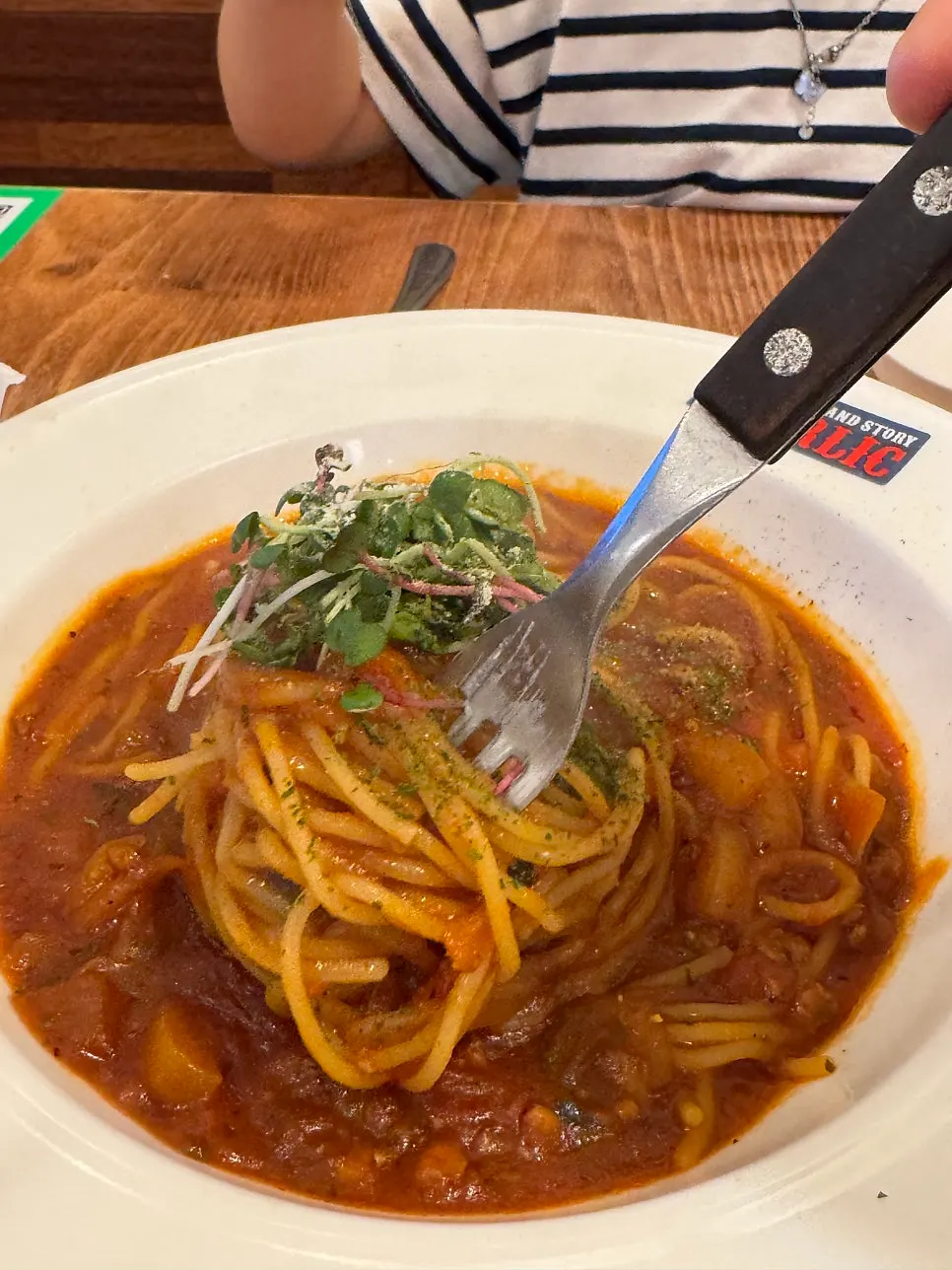 Child twirling noodles to eat