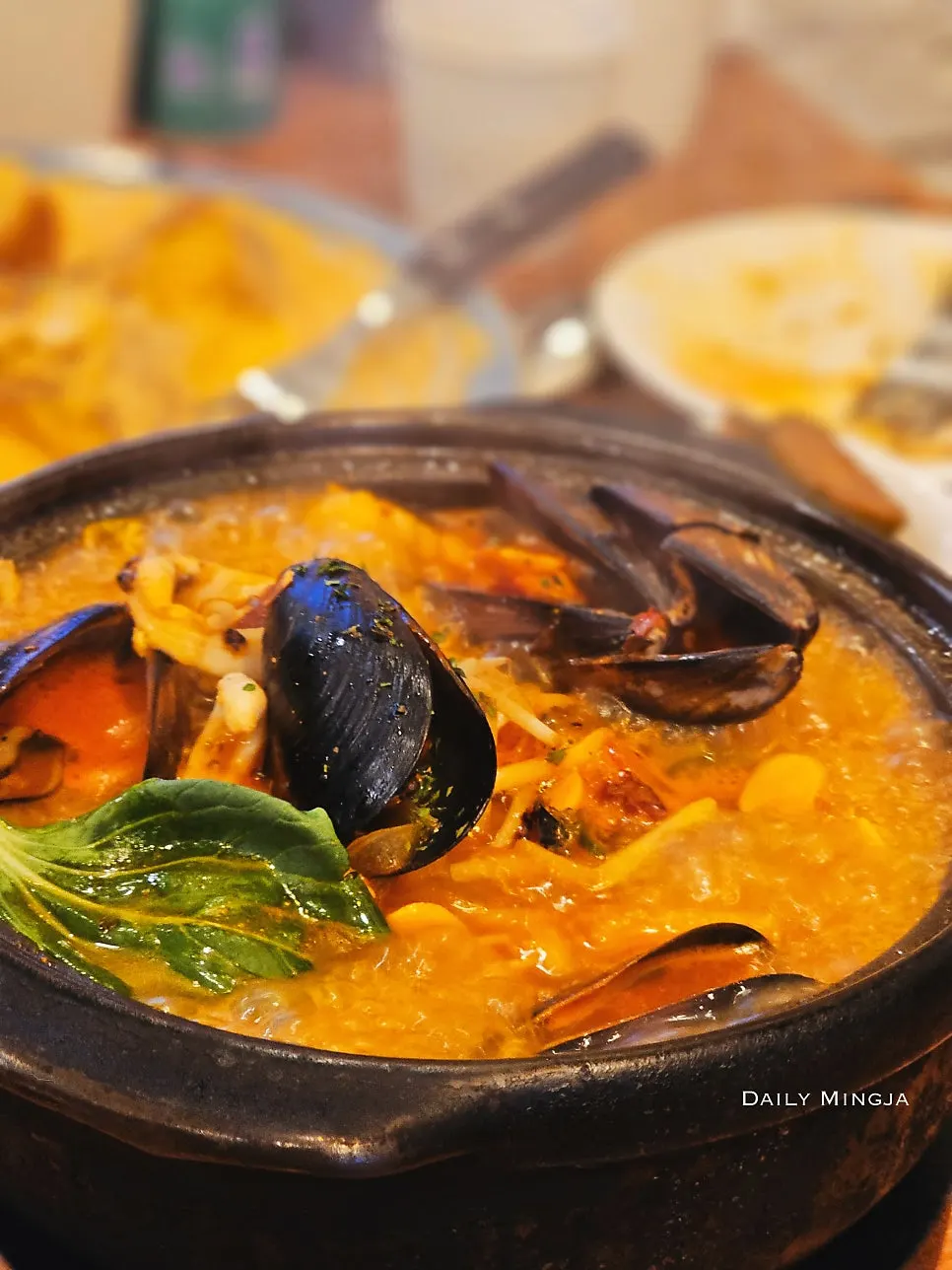 Squid and mussels rolled onto noodles in bbaechae