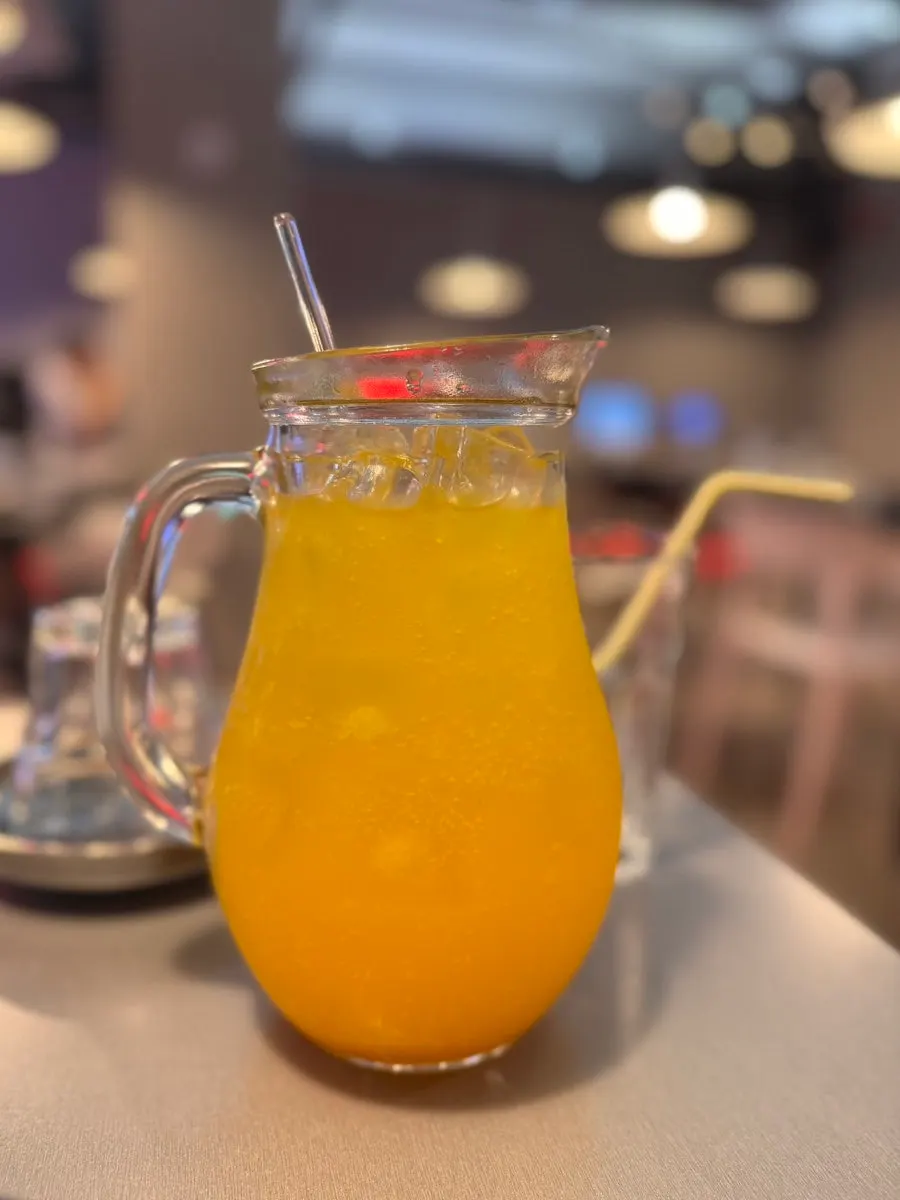 A large-sized glass of apple mango ade