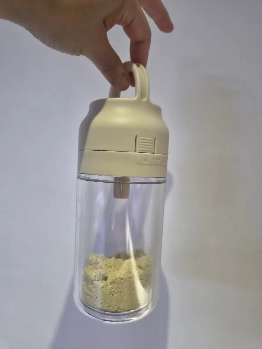 A glass of Baektae soy milk stirred and dissolved
