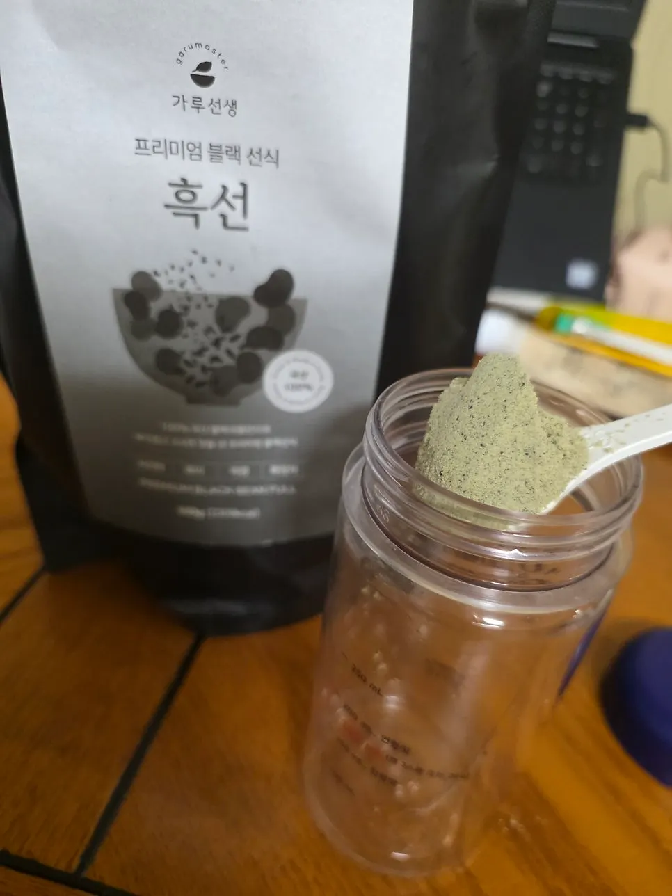 Gray grain powder scooped out with the included spoon