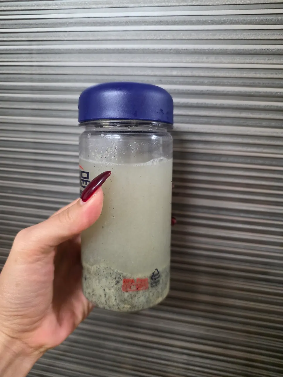 A glass of black-food grain drink mixed with water