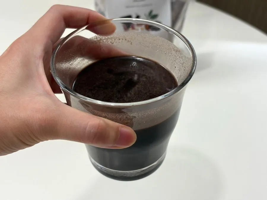 A cup of chocolate soy milk mixed with water