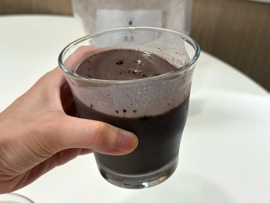 A cup of rich chocolate latte-like drink mixed with milk