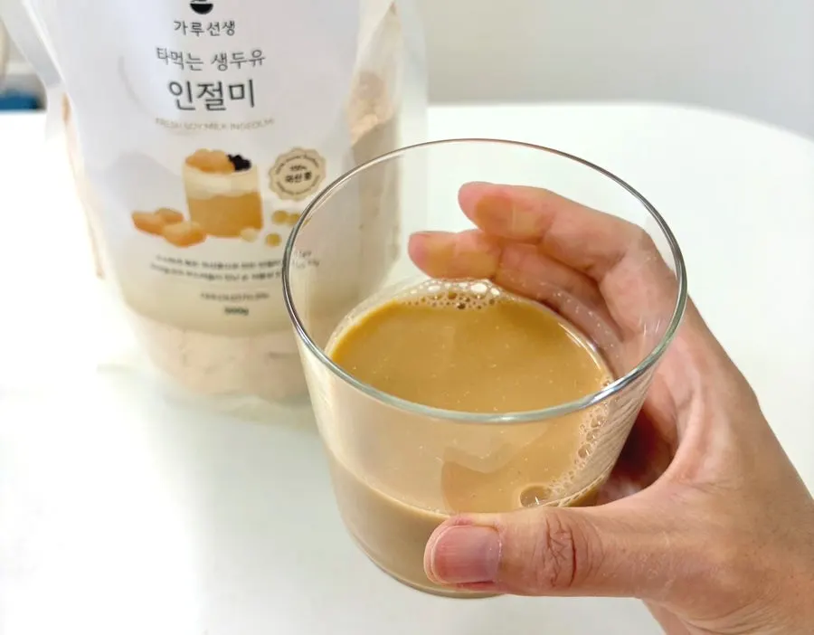 A finished glass of injeolmi soy milk mixed with water