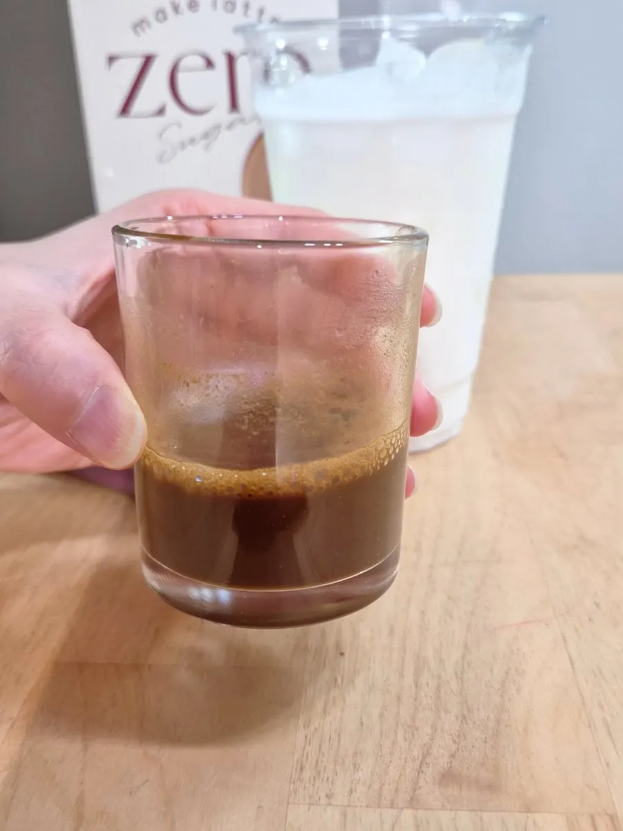 Milk tea stick alongside the finished drink