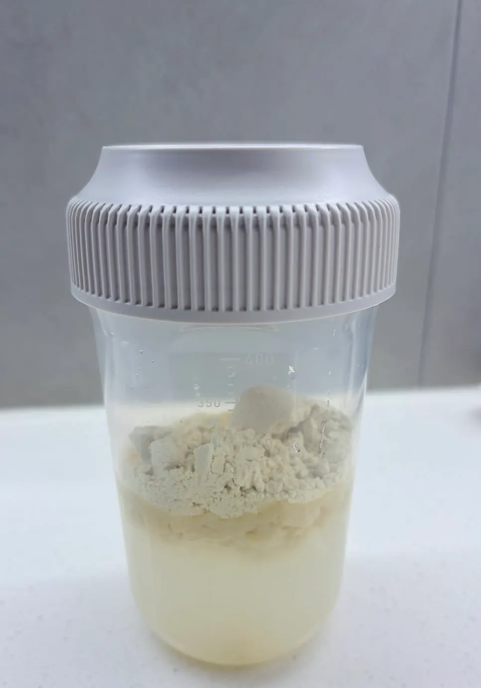 White soybean powder dissolving in a tumbler