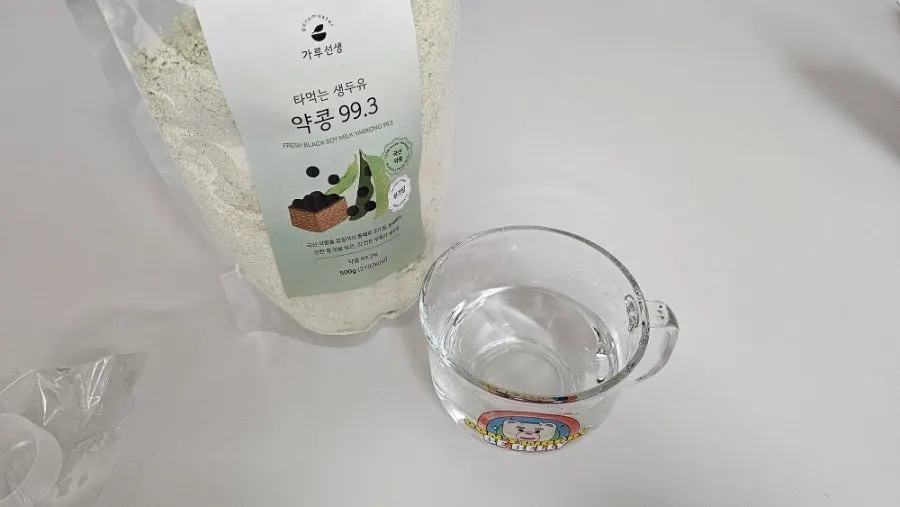 Pouring water into a cup with soy milk powder to mix