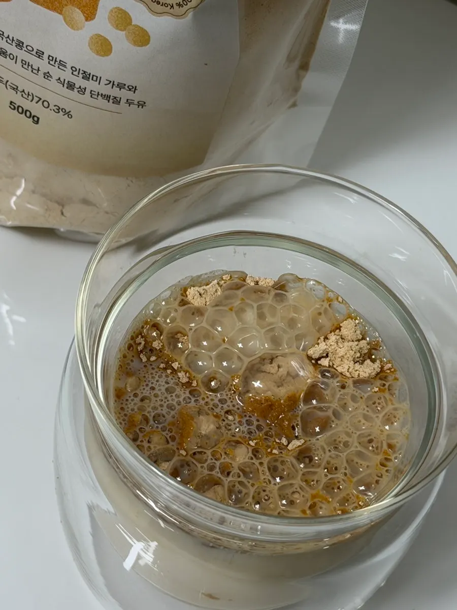 Stirring the powder into milk to make an injeolmi latte
