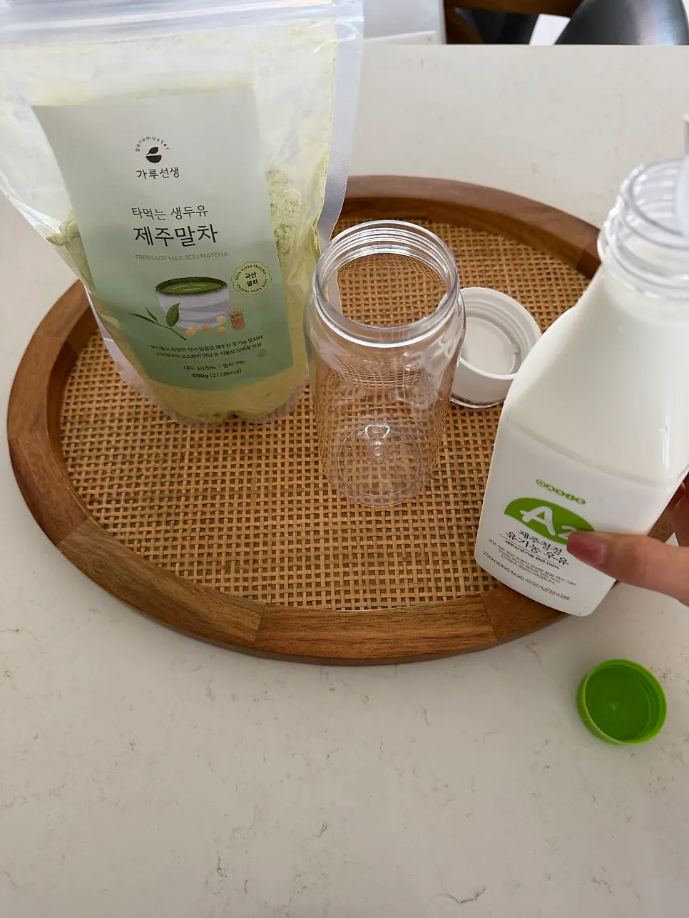 Two scoops of matcha powder added to a shaker