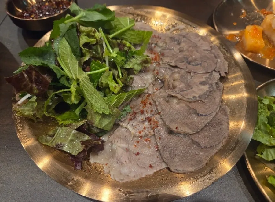 Gomtang and soju set on a table at Yukhwang
