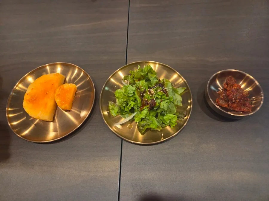 Basic side dishes: seokbakji, lettuce salad, and nakji-jeot