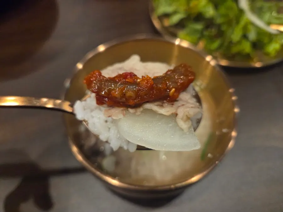 A bowl of Yukhwang gomtang served with rice already mixed in