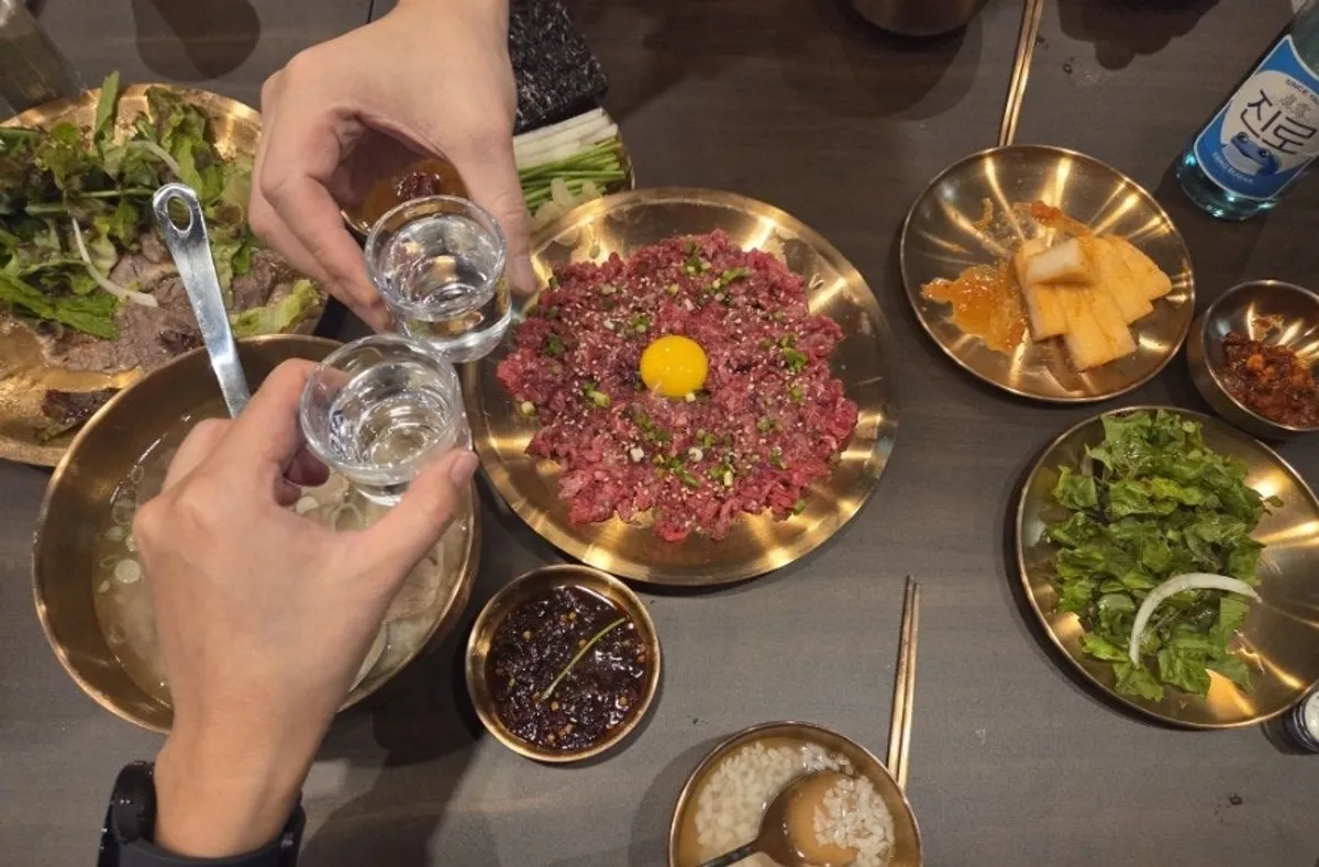 Yukhwang yukhoe topped with egg yolk and side vegetables