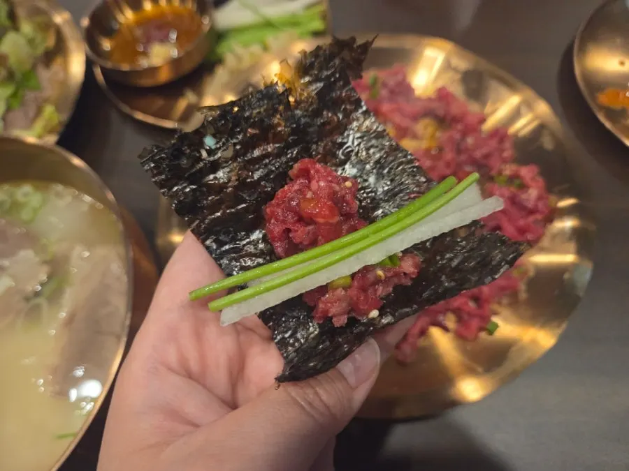 Yukhoe plate with the egg yolk broken open