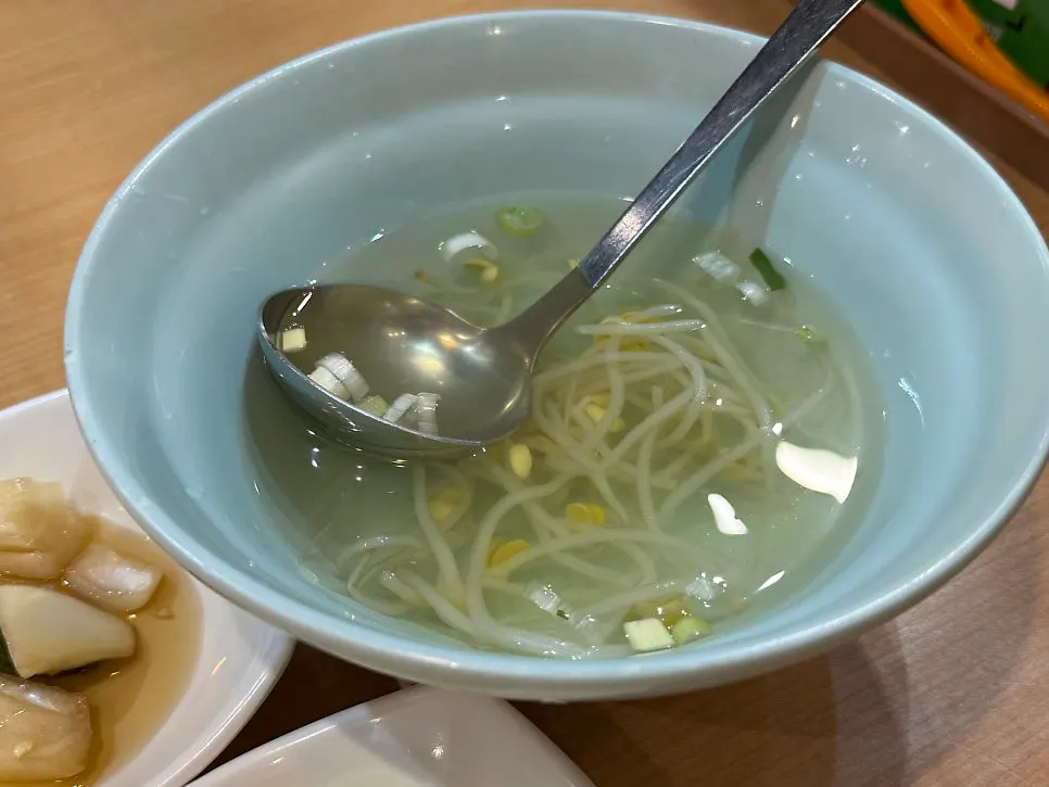 Salad, pickles, stir-fried fish cake, and bean sprout soup side dishes