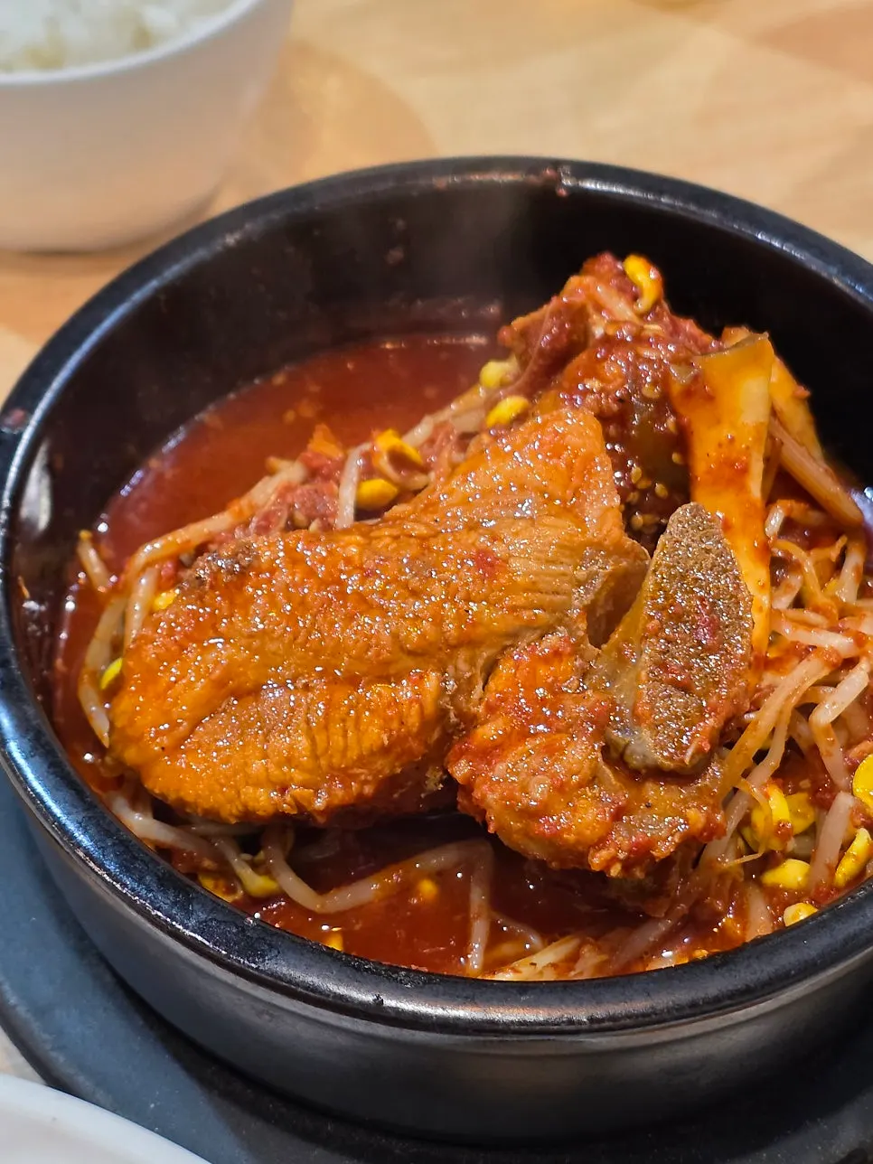 Freshly cooked rice pot served with the spicy braised short ribs