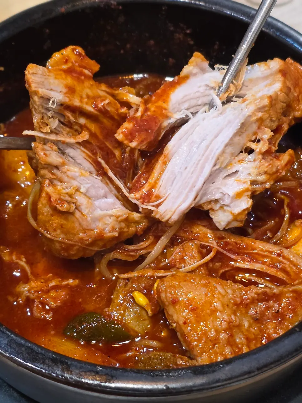 Spicy braised short ribs meat pulling apart along the grain