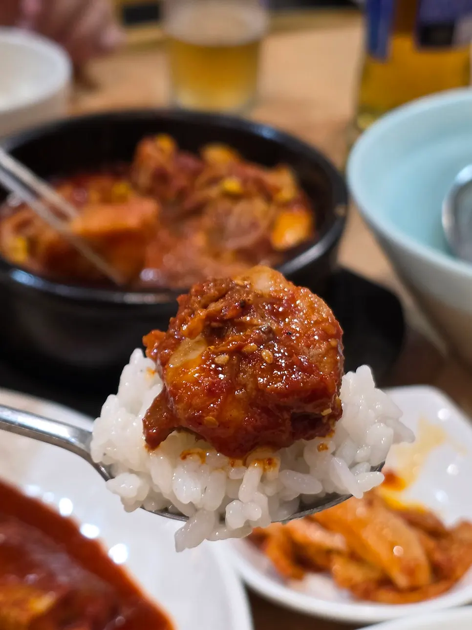 Spicy braised ribs and braised pollock placed over rice pot
