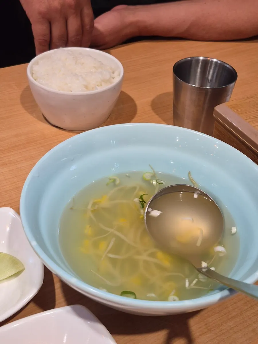 Table setting with bean sprout soup and pickled onion
