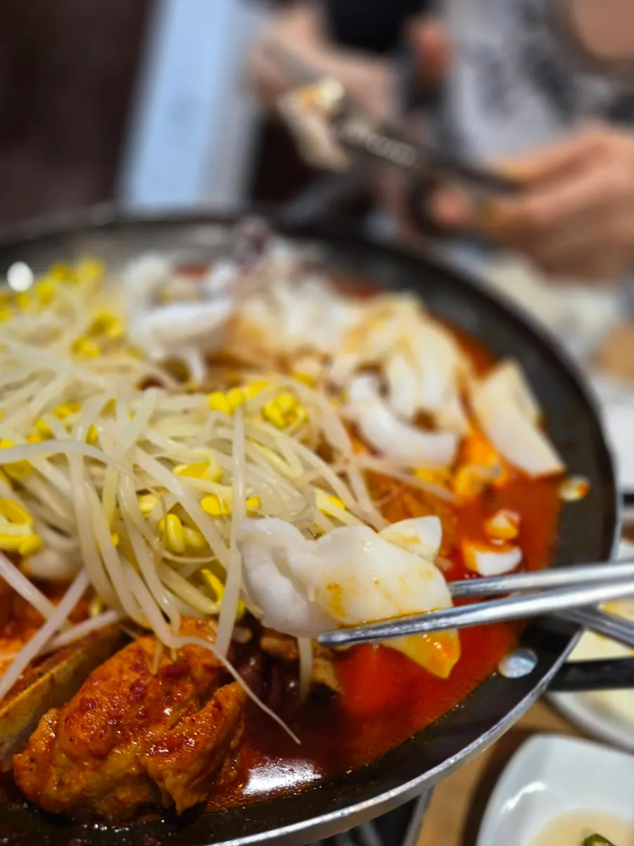 Close-up of the spicy braised ribs broth starting to boil