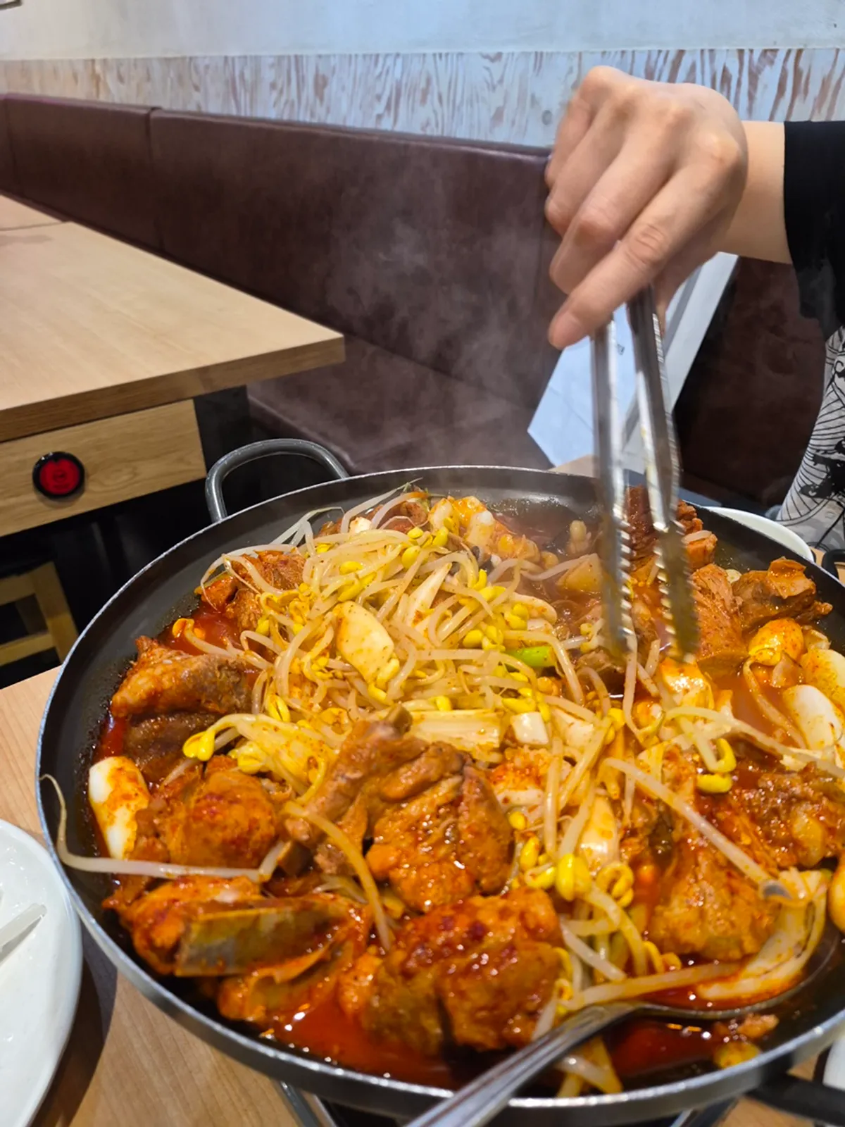 Pot full of ribs, bean sprouts, rice cake, and cuttlefish