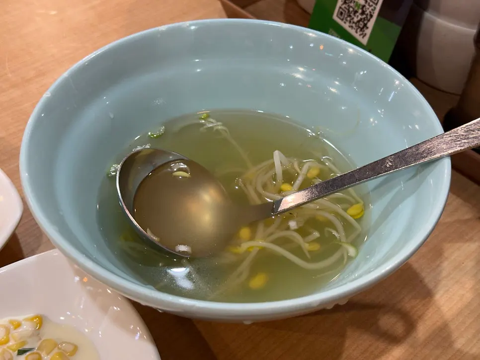 Warm bean sprout soup served alongside the meal