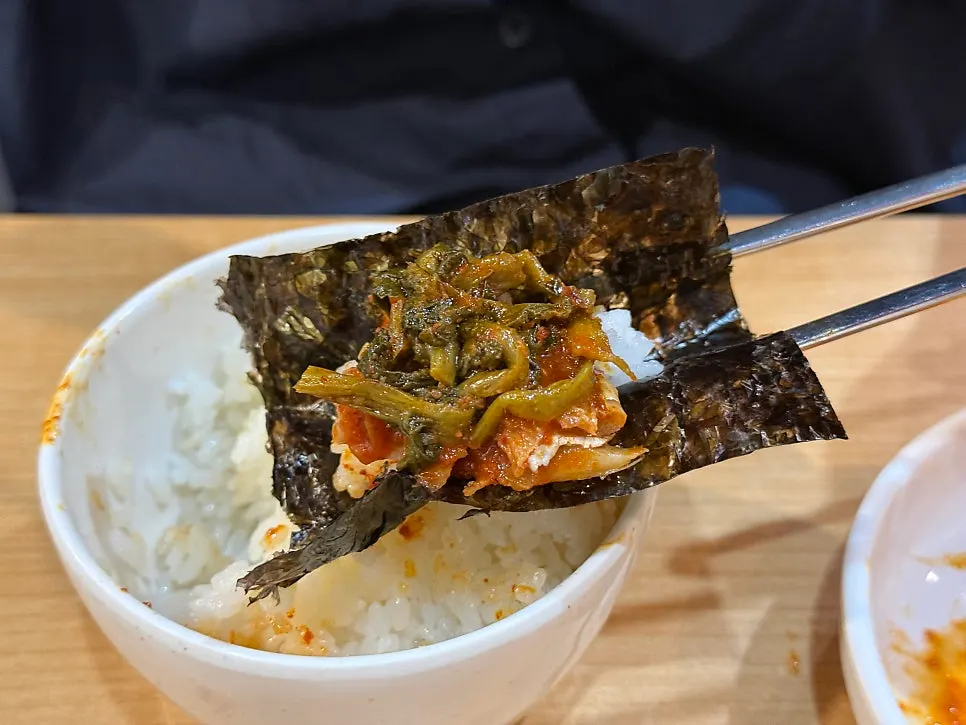 A wrap of dried laver with pollock meat and siraegi on top
