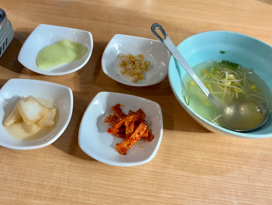 A full spread of bean-sprout soup and side dishes