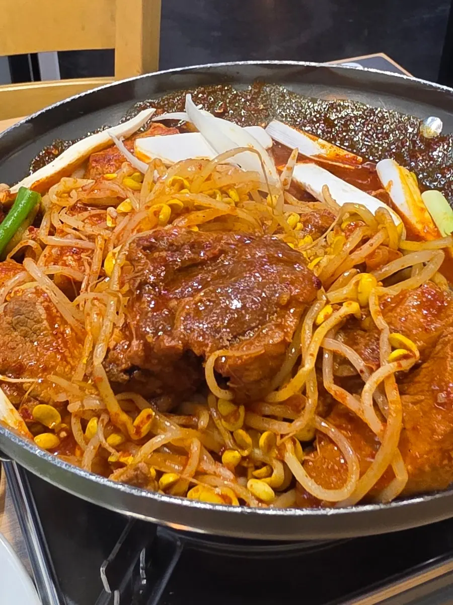 Braised ribs with reduced sauce and crisp bean sprouts