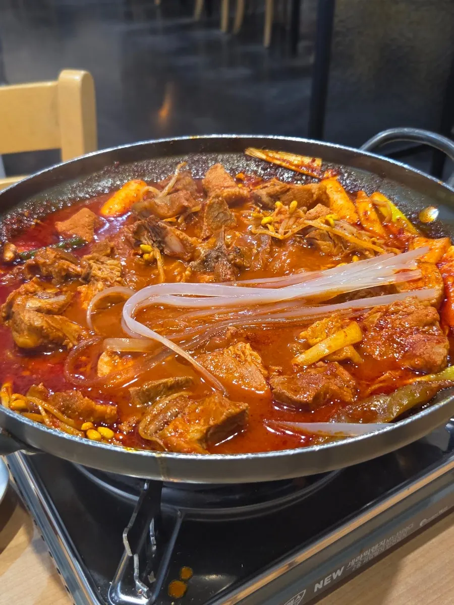 Wide glass noodles prepared before adding to the braised ribs