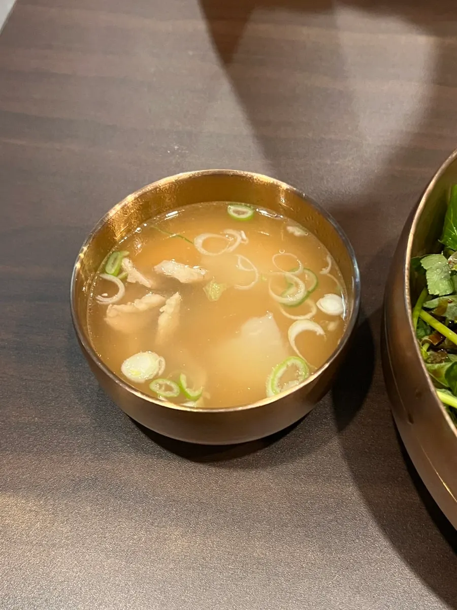 Broth served alongside the yukhoe bibimbap
