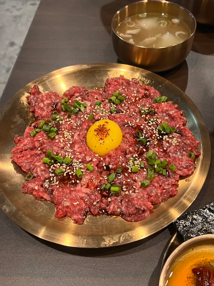 A plate of Yukhwang's yukhoe topped with egg yolk