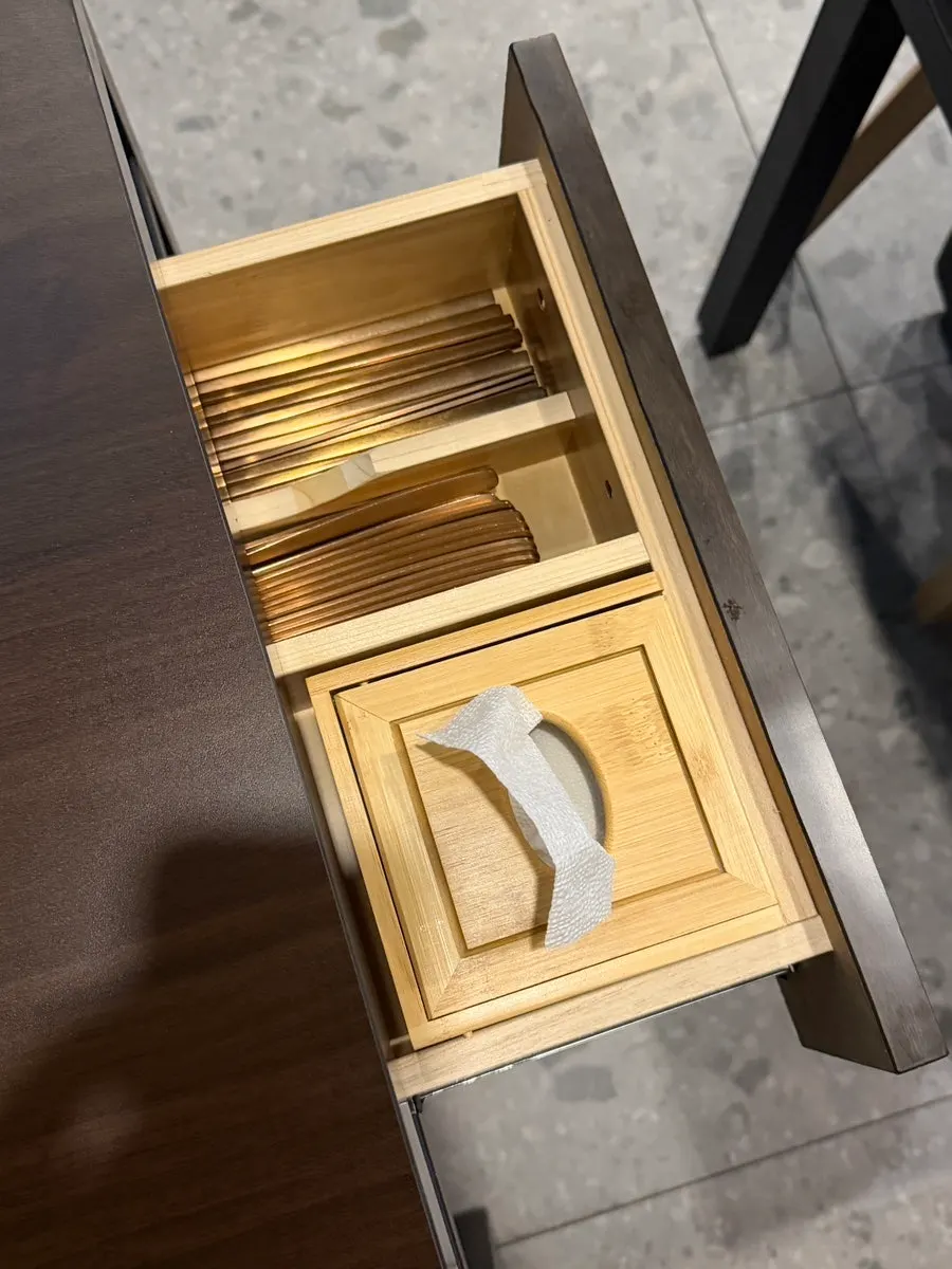 Table drawer containing utensils and tissues