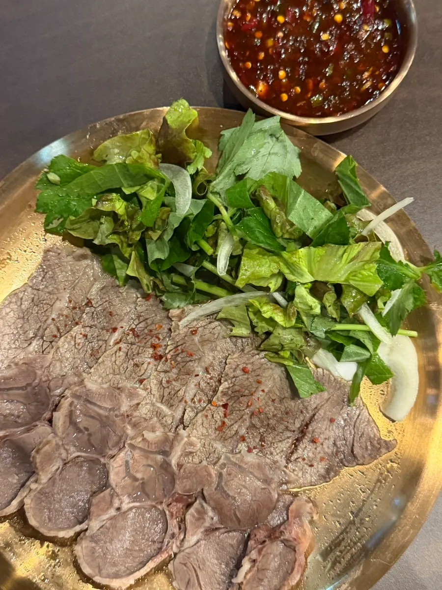Half plate of suyuk served with soy dipping sauce