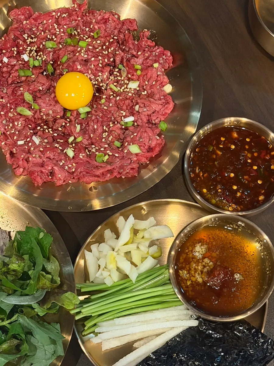 Hanwoo yukhoe served with seaweed, pear and minari