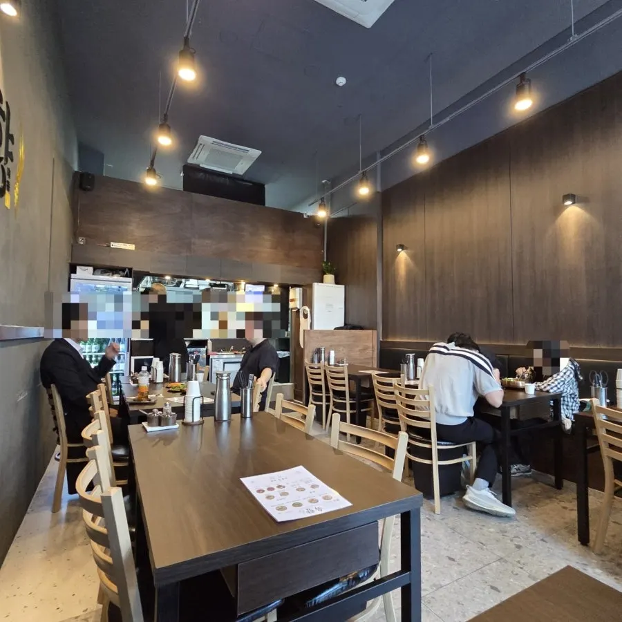 Yukhwang interior with dark wood-toned walls and lighting