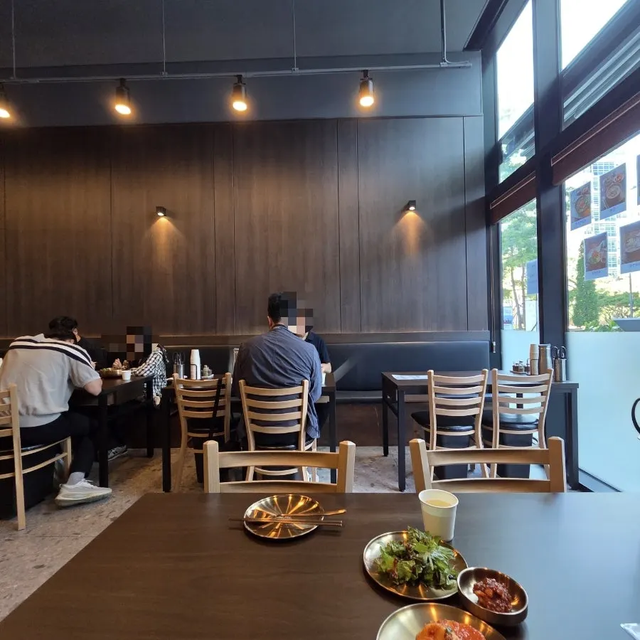 Yukhwang's high-ceilinged dining hall with soft lighting