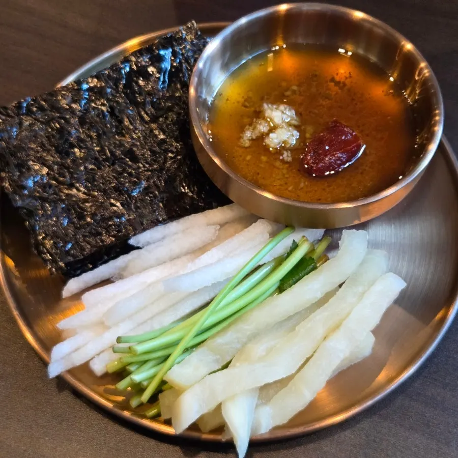 Pear, minari, radish, seaweed, and sauce served with the yukhoe