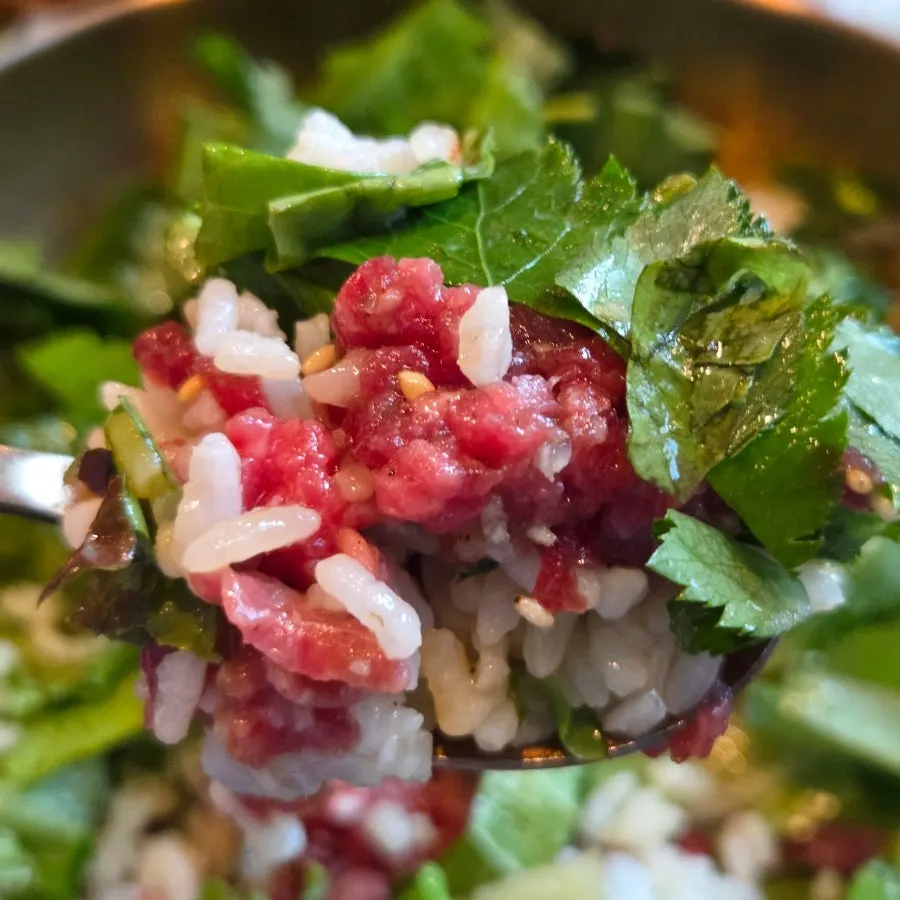 A mixed spoonful of yukhoe bibimbap