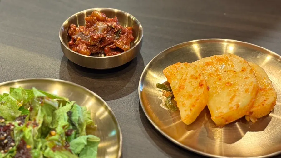 Yukhwang's basic side dishes: octopus jeotgal, seasoned lettuce, and seokbakji