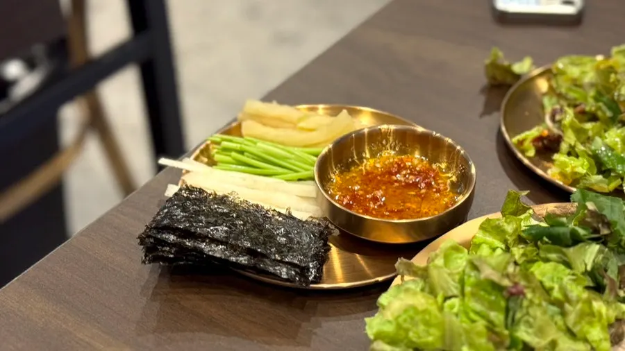 A piece of suyuk topped with octopus jeotgal