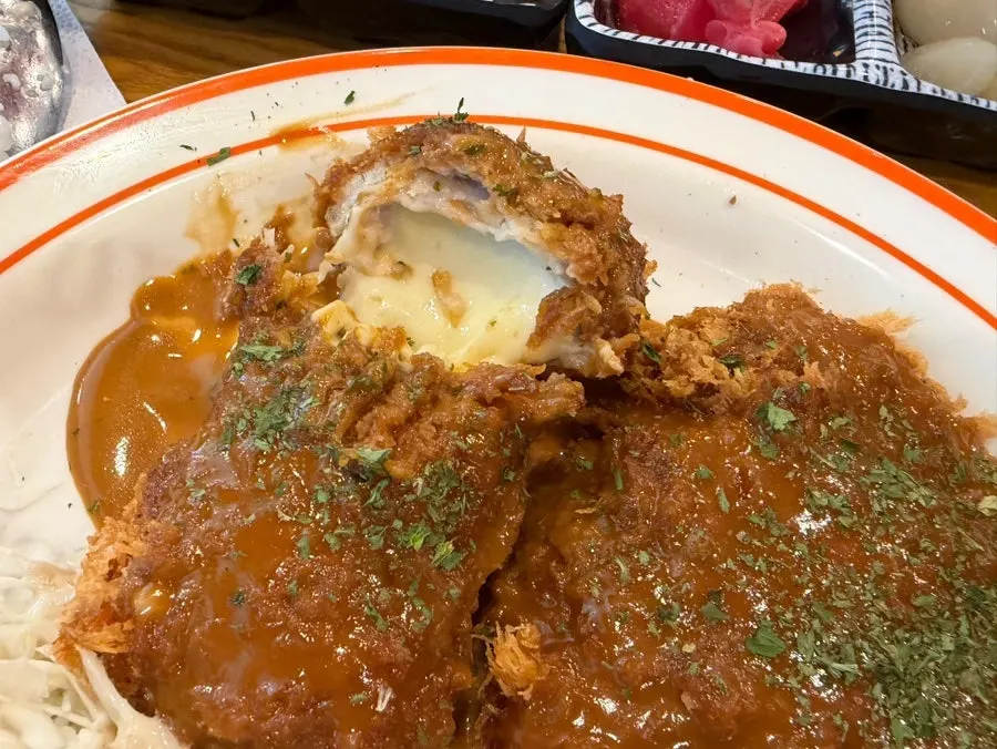 The hourglass served alongside the cheese tonkatsu
