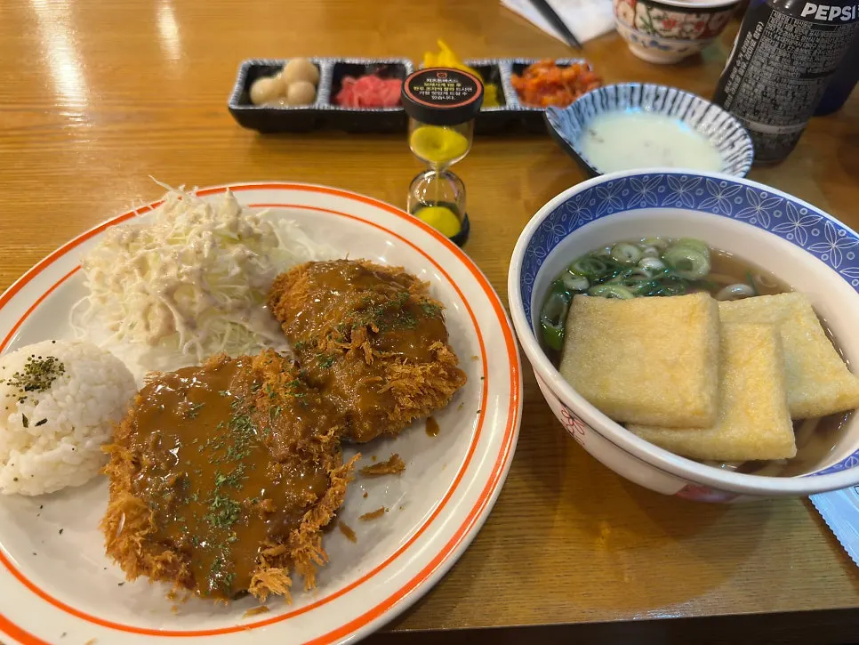 Table spread of tonkatsu kimchi nabe udon and gyudon