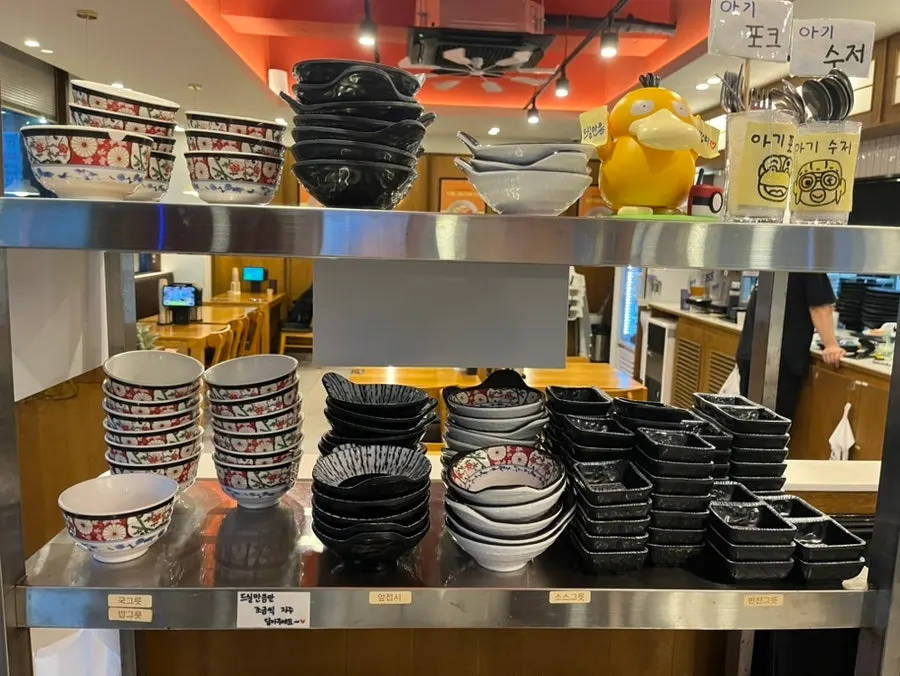 Self-serve bar with tableware, side dishes, and aprons