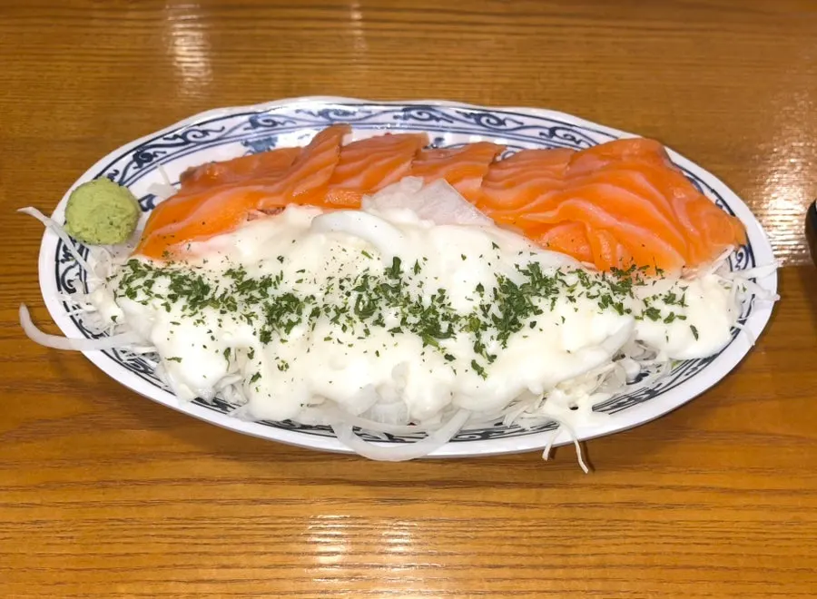Salmon salad piled high with onion sauce