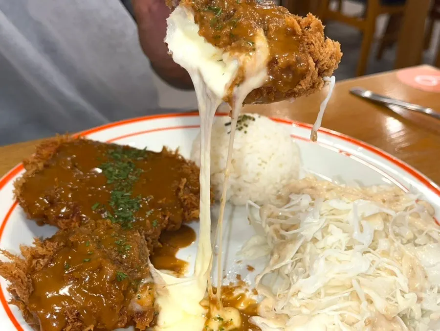 Cross-section of cheese tonkatsu with cheese oozing out