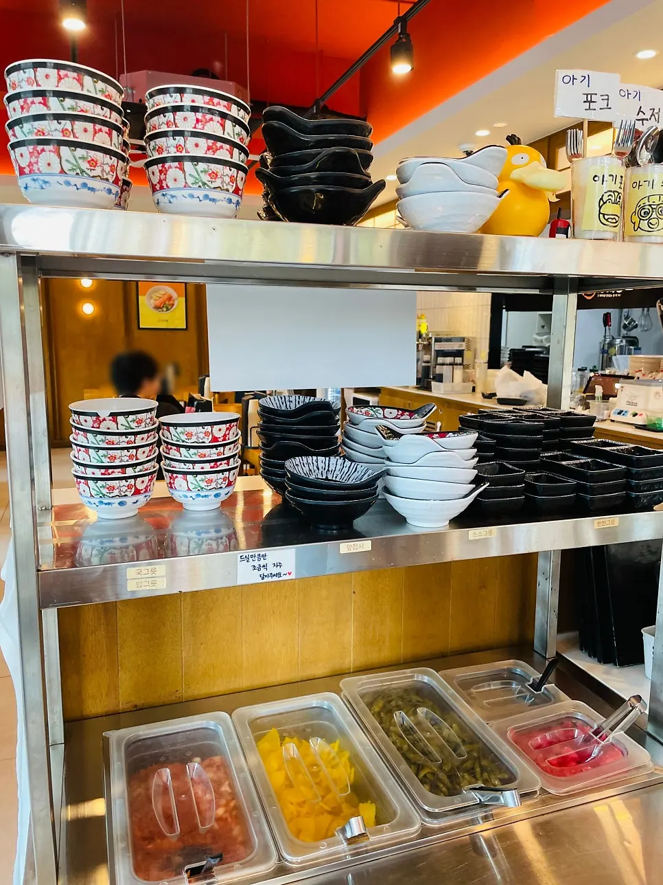 Self-serve bar with kimchi, pickled radish and rakkyo