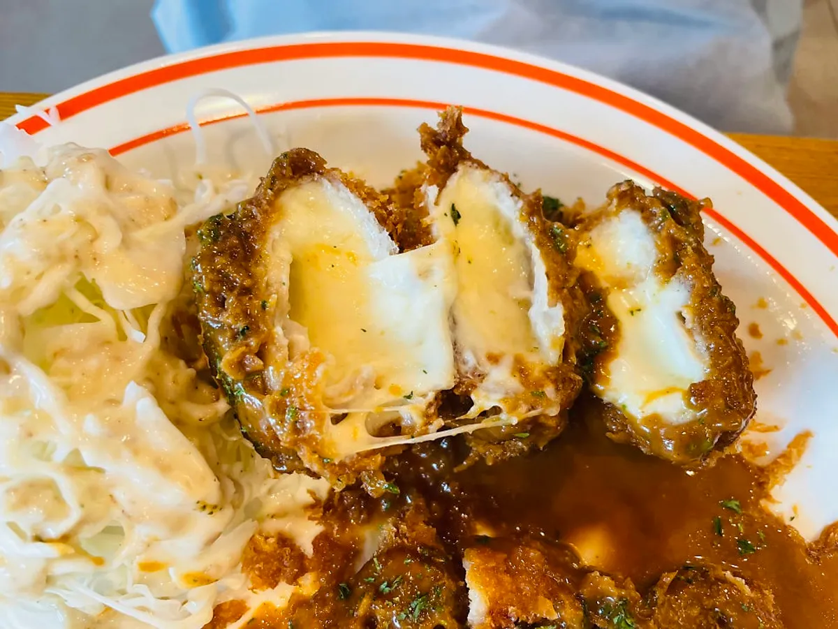 Cross-section of cheese tonkatsu with stretchy cheese