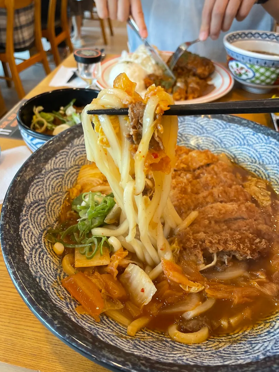 Tonkatsu lifted out of the broth